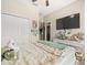 Cozy bedroom featuring a walk-in closet, ceiling fan, and modern white dresser at 4740 Tuscan Loon Dr, Tampa, FL 33619
