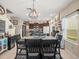 Open-concept dining room with a large wooden table set for a meal and stylish lighting at 4740 Tuscan Loon Dr, Tampa, FL 33619
