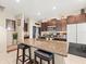 Kitchen with granite island, seating, stainless steel appliances, and ample cabinet space at 4740 Tuscan Loon Dr, Tampa, FL 33619