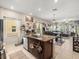 Kitchen with granite island and seating; open floor plan with dining and living areas at 4740 Tuscan Loon Dr, Tampa, FL 33619