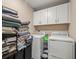 Bright laundry room with white cabinets and washer and dryer hookups, perfect for efficient home management at 4740 Tuscan Loon Dr, Tampa, FL 33619