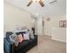 Upstairs loft area with neutral carpet, ceiling fan, comfortable seating, and plenty of room at 4740 Tuscan Loon Dr, Tampa, FL 33619