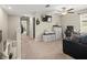 Upstairs living room area with neutral carpet, ceiling fan, tv, and comfortable seating at 4740 Tuscan Loon Dr, Tampa, FL 33619
