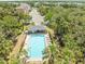 Community pool featuring sun loungers and verdant surrounding landscape at 4740 Tuscan Loon Dr, Tampa, FL 33619