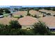 Aerial shot of an expansive residential neighborhood featuring yellow homes with red roofs and neatly arranged streets at 4837 Rainbow Race, New Port Richey, FL 34652
