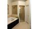 Bathroom showcasing a garden tub, shower, and neutral color palette at 4837 Rainbow Race, New Port Richey, FL 34652