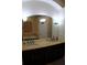 Bathroom featuring dual sinks, decorative lighting, and a large mirror at 4837 Rainbow Race, New Port Richey, FL 34652