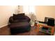Cozy room with accent chair, ottoman and dark floors at 4837 Rainbow Race, New Port Richey, FL 34652