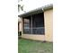 Exterior view of the screened-in patio with outdoor furniture and view of the yard at 4837 Rainbow Race, New Port Richey, FL 34652