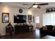 Bright living room featuring a media center, wood flooring, and comfortable seating, perfect for relaxation at 4837 Rainbow Race, New Port Richey, FL 34652