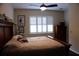 Bedroom with natural light through shuttered windows and a wooden dresser at 4837 Rainbow Race, New Port Richey, FL 34652