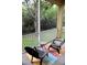 Relaxing screened porch with outdoor chairs and view of the yard at 4837 Rainbow Race, New Port Richey, FL 34652