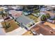 Aerial view of a charming home with a fenced backyard, shed, and lush landscaping at 4932 Gaslight Ave, Holiday, FL 34690