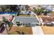 Overhead shot of a quaint residence with a fenced backyard, shed, and beautiful landscaping at 4932 Gaslight Ave, Holiday, FL 34690
