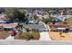 Aerial view of a property with a lush, fenced backyard and well-maintained landscaping at 4932 Gaslight Ave, Holiday, FL 34690