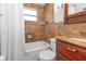 Bathroom features a tile surround, shower, tub, vanity, and lighting at 4932 Gaslight Ave, Holiday, FL 34690