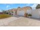 Inviting home featuring an attached garage and lovely potted plants by the entrance at 4932 Gaslight Ave, Holiday, FL 34690