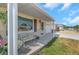 Inviting front porch with bench seating and attractive column detailing at 4932 Gaslight Ave, Holiday, FL 34690