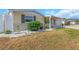 Beautifully landscaped front yard with decorative plants, and exterior shutters at 4932 Gaslight Ave, Holiday, FL 34690