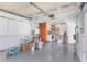 The garage interior features epoxy flooring, with the laundry area accessible through a door at 4932 Gaslight Ave, Holiday, FL 34690