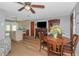 Open concept living area with a dining table, TV, and adjacent kitchen with a breakfast bar at 4932 Gaslight Ave, Holiday, FL 34690