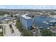Stunning aerial view of waterfront condo building with boat docks and beautiful blue waters and surrounding community at 4939 Floramar Ter # 902, New Port Richey, FL 34652