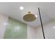Stunning bathroom boasts green glass tile shower and rainfall shower head at 4939 Floramar Ter # 902, New Port Richey, FL 34652
