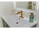 Stylish bathroom with modern sink fixtures, a lighted mirror, and decorative accessories at 4939 Floramar Ter # 902, New Port Richey, FL 34652