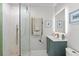 Elegant bathroom with vanity, a backlit mirror, and a glass-enclosed shower at 4939 Floramar Ter # 902, New Port Richey, FL 34652