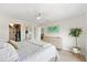 Bright bedroom with a large closet, dresser, and modern decor at 4939 Floramar Ter # 902, New Port Richey, FL 34652