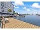 View of boat docked at the pier with condo in background on a sunny day at 4939 Floramar Ter # 902, New Port Richey, FL 34652