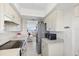 Charming kitchen with stainless appliances, light cabinets, and easy access to the living area at 4939 Floramar Ter # 902, New Port Richey, FL 34652