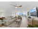 Spacious living room with modern furnishings, ceiling fans, and a beautiful view of the city at 4939 Floramar Ter # 902, New Port Richey, FL 34652
