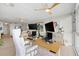 Bright, modern home office with dual monitors, stylish desk, and comfortable white ergonomic chair at 4939 Floramar Ter # 902, New Port Richey, FL 34652
