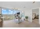 Spacious office with a large window, light hardwood flooring, and a ceiling fan providing a comfortable workspace at 4939 Floramar Ter # 902, New Port Richey, FL 34652