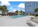 Inviting community pool with covered lounge area and palm trees, perfect for relaxation at 4939 Floramar Ter # 902, New Port Richey, FL 34652