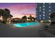Outdoor swimming pool with lounge chairs and a gazebo at sunset at 4939 Floramar Ter # 902, New Port Richey, FL 34652