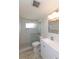Bathroom featuring a glass shower, a white vanity and a decorative mirror at 5008 Forecastle Dr, New Port Richey, FL 34652