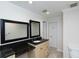 Bathroom featuring double mirrors, a vanity with dark granite countertop, and neutral tile flooring at 5008 Forecastle Dr, New Port Richey, FL 34652