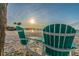 Relaxing beach view featuring Adirondack chairs overlooking the ocean at sunset at 5008 Forecastle Dr, New Port Richey, FL 34652