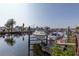 Boat dock featuring several boats, boat lifts and a water view at 5008 Forecastle Dr, New Port Richey, FL 34652