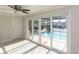 Indoor space with large sliding glass doors leading to a screened-in pool area and waterfront view at 5008 Forecastle Dr, New Port Richey, FL 34652
