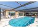 View of the in-ground swimming pool with enclosure and lounge seating at 5008 Forecastle Dr, New Port Richey, FL 34652