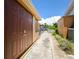 Property exterior featuring a quaint walkway showcasing the side of the home and landscaping at 5008 Forecastle Dr, New Port Richey, FL 34652