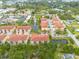 Aerial view of a multi-unit residential complex featuring well-maintained landscaping, ponds, and community spaces at 5041 Royal Palms Way # 203, New Port Richey, FL 34652