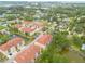 Aerial view of condo community with ponds, mature trees and landscaping at 5041 Royal Palms Way # 203, New Port Richey, FL 34652