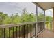 A screened-in balcony providing a private outdoor space with views of lush greenery at 5041 Royal Palms Way # 203, New Port Richey, FL 34652