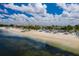 Expansive beach view with white sand, palm trees, cabanas and a clear blue sky with fluffy clouds at 5041 Royal Palms Way # 203, New Port Richey, FL 34652