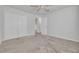 Neutral bedroom with a ceiling fan, carpeted floor, and closet with folding doors at 5041 Royal Palms Way # 203, New Port Richey, FL 34652