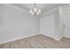 Dining area features modern chandelier, wood flooring, and a large closet at 5041 Royal Palms Way # 203, New Port Richey, FL 34652